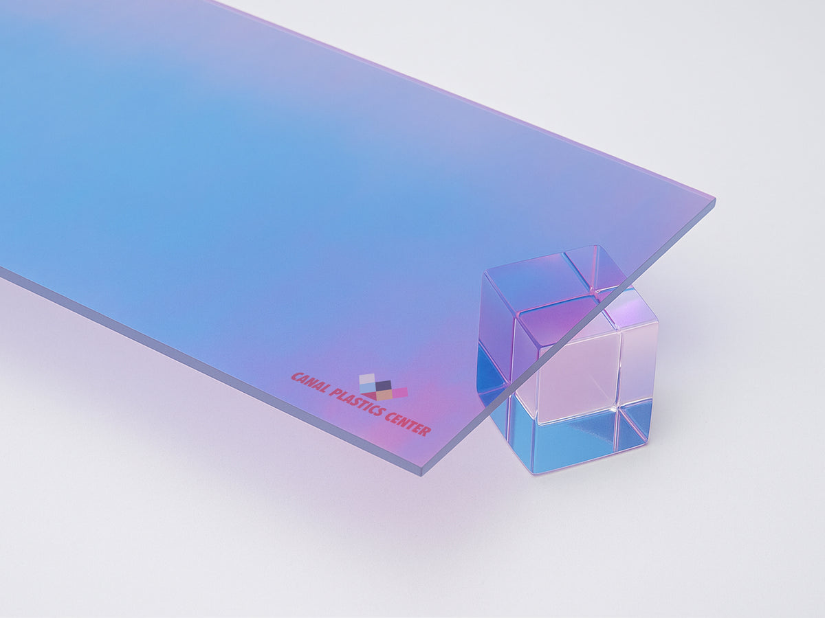 Aura Iridescent Acrylic Sheet by Canal Plastics Center — cool blue to magenta gradient with reflective film and transparent edge resting on acrylic cube