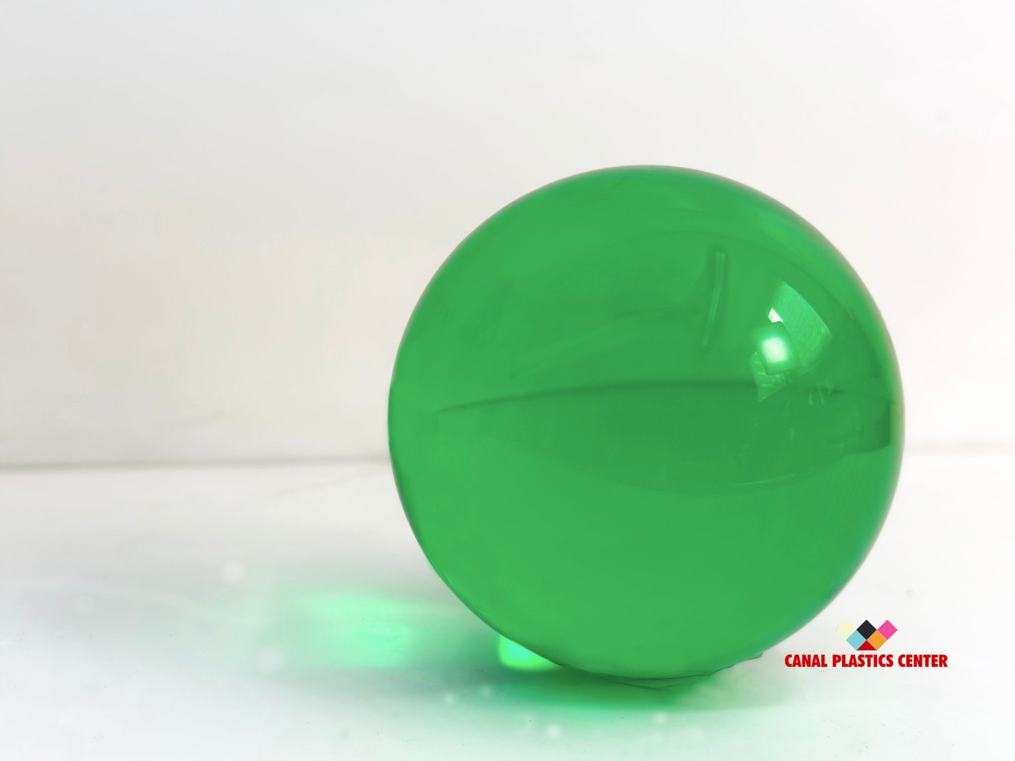 Canal Plastics Center Green Transparent Acrylic Sphere, wide view, bright background - for decorative and artistic uses to scientific and industrial purposes such as displays and visual merchandising, art installations and sculptures, photography props and effects, home decor, costume and prop making, optical applications, model making and prototyping, furniture accessories and more