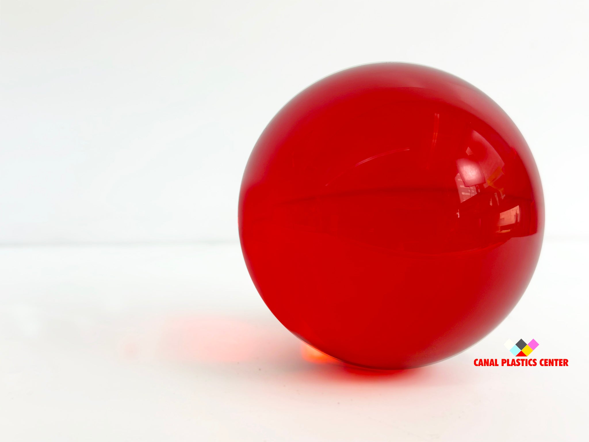 Canal Plastics Center Red Transparent Acrylic Sphere, wide view, bright background - for decorative and artistic uses to scientific and industrial purposes such as displays and visual merchandising, art installations and sculptures, photography props and effects, home decor, costume and prop making, optical applications, model making and prototyping, furniture accessories and more